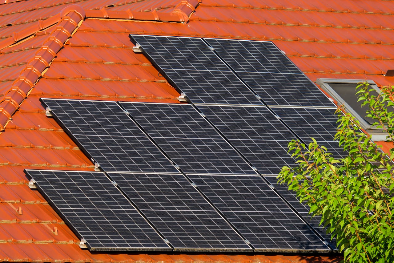 Close-up of solar panels on a red tiled roof in Croatia, highlighting renewable energy.